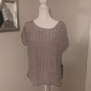 NWT 100% silk silver cap sleeve top with silver circle pattern design.